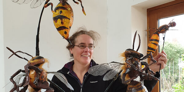 Hilary Norris with orchard insects made by the Fetch Theatre Company